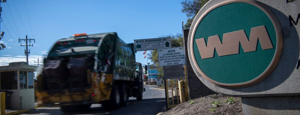 A Waste Management Inc. garbage collection truck enters the company's